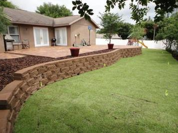 hardscapes concrete block retaining wall in backyard of house